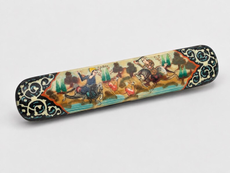 Vintage Persian miniature wooden pen holder in a white studio, showcasing detailed hand-painted hunting scene, intricate marquetry accents, and timeless handcrafted desk decor.