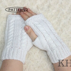 May include: White knitted fingerless gloves with a cable knit pattern. The gloves are shown on a white fuzzy surface. The text "PATTERN" is visible in a circle above the gloves. The text "KHH" is visible in the lower right corner of the image.