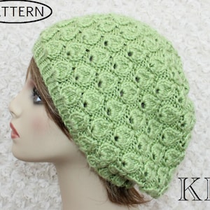 May include: A light green knitted beanie with a textured pattern. The beanie is on a white background.
