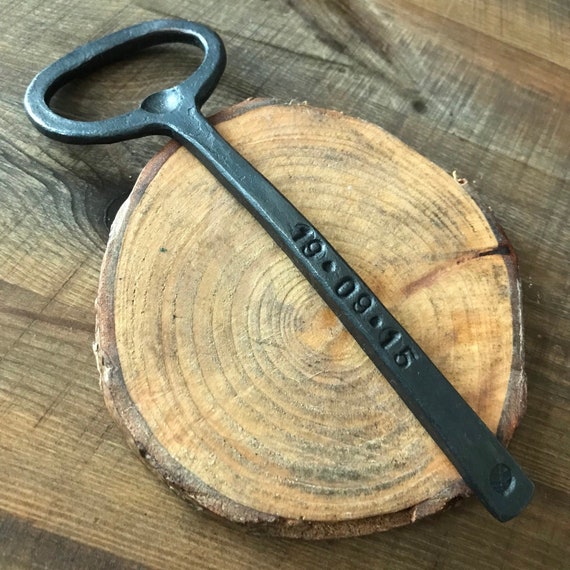 Blacksmith-forged iron bottle opener with personalization — the 76 favorites signal real demand for this as a standout anniversary or groomsman gift.