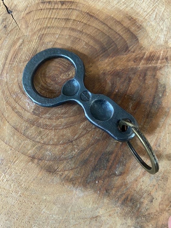 A blacksmith actually hammered this bottle opener keyring from raw steel — functional, rugged, and carries that 'made by a real human at an anvil' energy no factory can replicate.