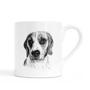 May include: White ceramic mug with a black and white illustration of a beagle's face. The dog's portrait is detailed, with emphasis on its eyes and markings. The mug has a curved handle, perfect for enjoying a hot beverage.