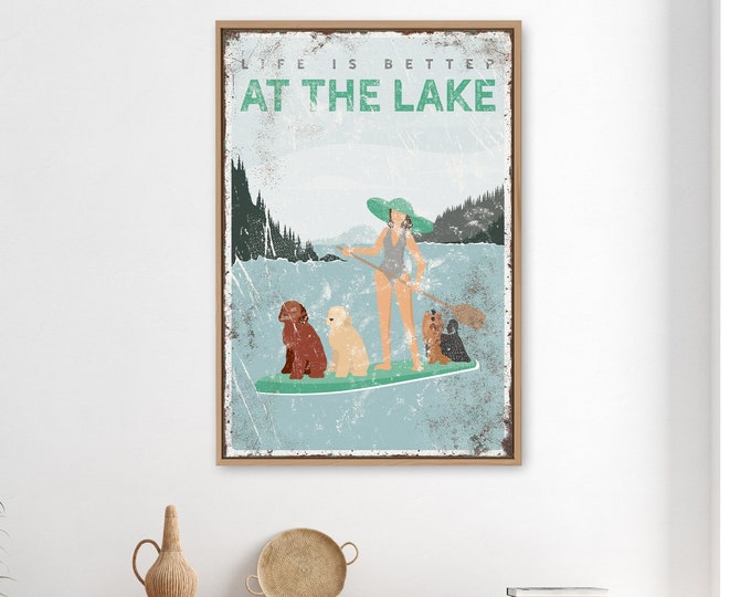 vintage AT THE LAKE sign, woman paddleboarding with three dogs, yorkshire terrier and goldendoodle shown, life is better at the lake {vpl}