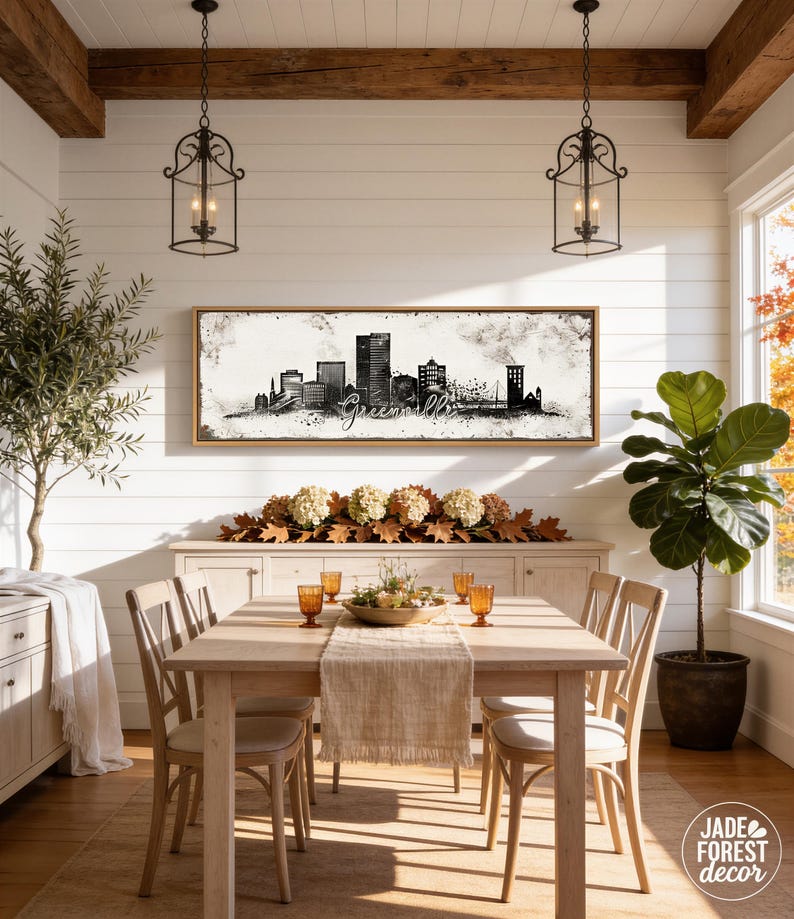 a cozy dining room with a wooden table and chairs, a large framed city skyline artwork on the wall, and various decorative elements such as potted plants and vases.