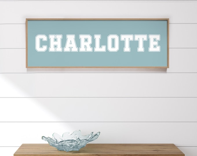 Kids room name sign blue, dusty blue varsity lettering above the bed