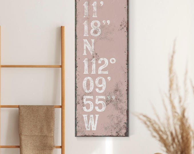 Shell toned pink and white sign, custom GPS coordinates in tall stacked lettering