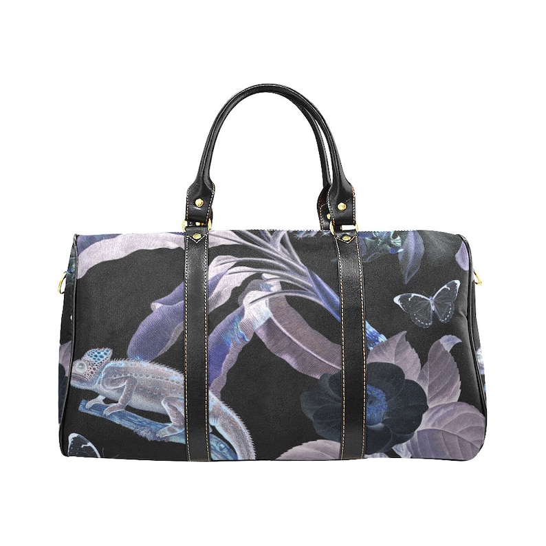 May include: Black travel bag with a floral print featuring butterflies and a chameleon. The print is in shades of blue, purple, and white on a black background.