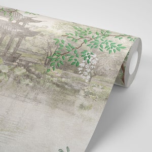 May include: A roll of wallpaper featuring a muted, artistic landscape scene with a pagoda structure, soft green foliage, and white floral clusters on a textured, light grey background. The design depicts a serene garden setting with trees.