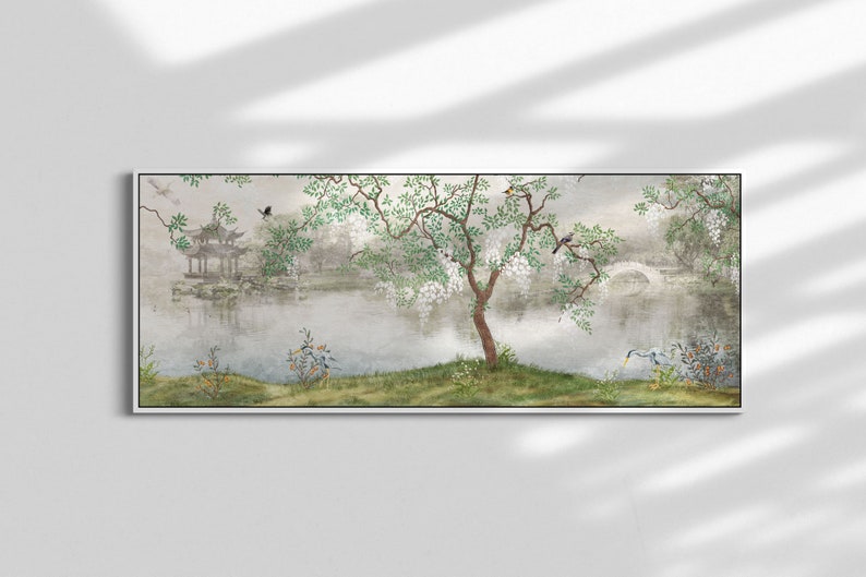 May include: A panoramic wall art print featuring a serene landscape with a calm lake, a traditional pagoda, and an arched stone bridge. A central tree with white blossoms and green leaves stands on the grassy bank, accompanied by small birds.