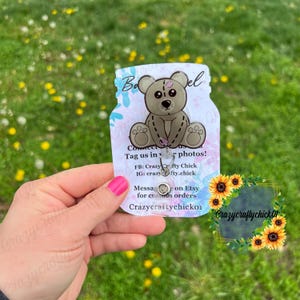 May include: A clear plastic keychain with a cute cartoon bear design. The keychain has a metal ring and a tag that says "Connect with us! Tag us in your photos! FB: Crazy Crafty Chick IG: crazycrafty.chick Message us on Etsy for custom orders Crazycraftychicko1"