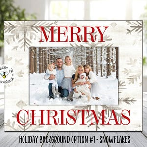 May include: White picture frame with a snowflake design and the words "Merry Christmas" in red. The frame has a photo of a family in a snowy forest.