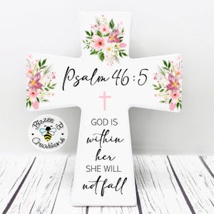 May include: White wooden cross with pink floral designs and the text "Psalm 46:5" and "GOD IS within her SHE WILL not fall".
