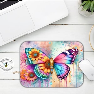 May include: A colorful butterfly with blue, pink, and purple wings is surrounded by yellow sunflowers and watercolor splatters. The background is a light blue and pink watercolor wash.