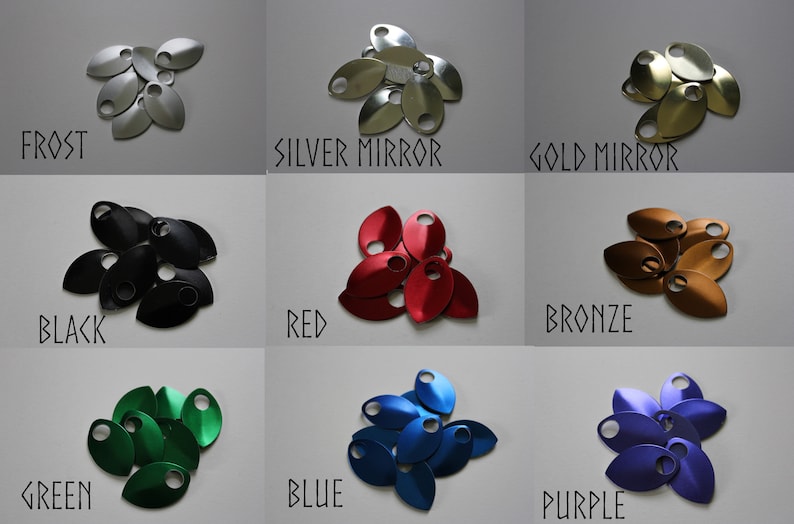 May include: Nine metal scales in various colours, including frost, silver mirror, gold mirror, black, red, bronze, green, blue, and purple. The scales are arranged in a pile, with the colours clearly visible.