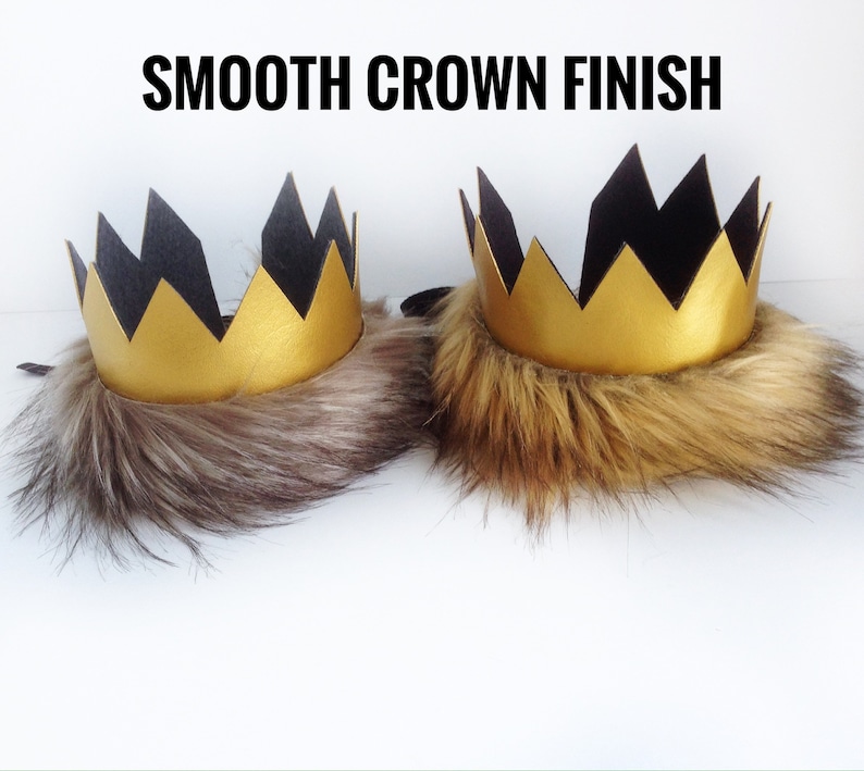 May include: Two gold crowns with black felt points and a faux fur trim. The text "SMOOTH CROWN FINISH" is at the top of the image.