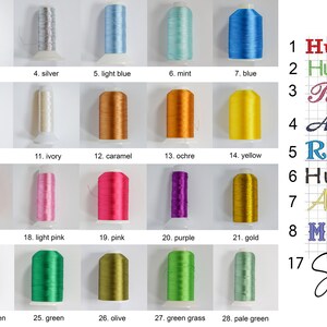 May include: A collection of embroidery thread spools in various colors, including black, gray, white, and blue. The image also displays a color chart with names like "Hudson" and "Remi" in different fonts, ideal for personalized embroidery projects.