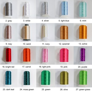 May include: A collection of 28 spools of thread in various colors, including black, gray, white, silver, light blue, mint, blue, brown, rosy, sand, ivory, caramel, ochre, yellow, red, bright red, carrot, light pink, pink, purple, gold, dark blue, dark teal, moss green, green, olive, green grass, and pale green.