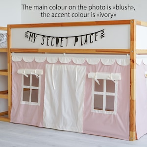 May include: A wooden bunk bed with a pink and white tent-like canopy. The canopy has two windows and a white curtain in the center. The bed has a shelf on the side and a sign that says "MY SECRET PLACE" above the canopy.