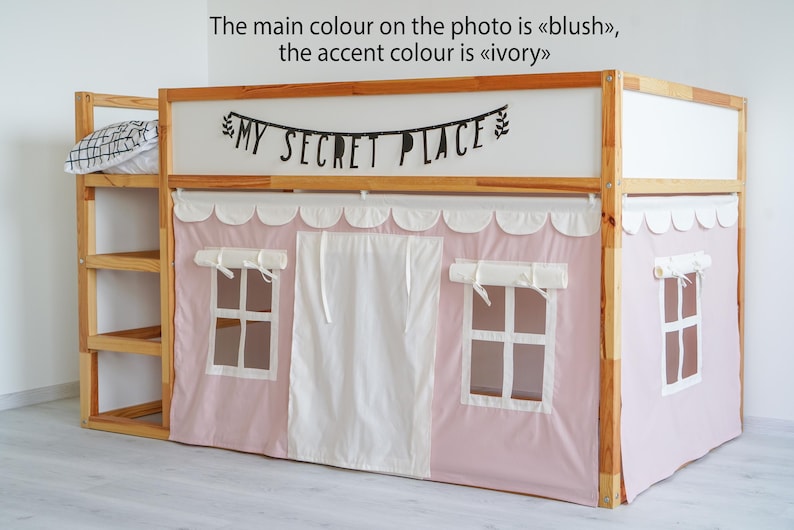 May include: A wooden bunk bed with a pink and white tent-like canopy. The canopy has two windows and a white curtain in the center. The bed has a shelf on the side and a sign that says "MY SECRET PLACE" above the canopy.