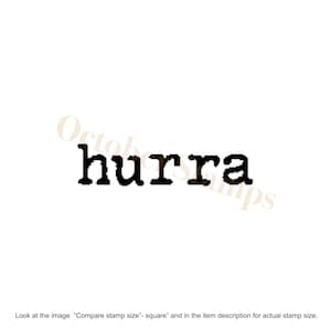 May include: Black and white rubber stamp with the word "hurra" printed on it.