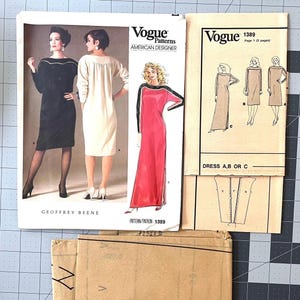 May include: Vogue Patterns American Designer dress sewing patterns. The image shows several pattern envelopes with illustrations of dresses. The patterns include designs by Geoffrey Beene. The text "Dress A, B or C" is visible.