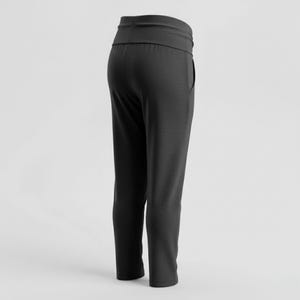 May include: Dark gray athletic pants with a wide waistband and a relaxed fit. The pants have a single pocket on the side and a slightly tapered leg. The fabric appears to be a soft, knit material.