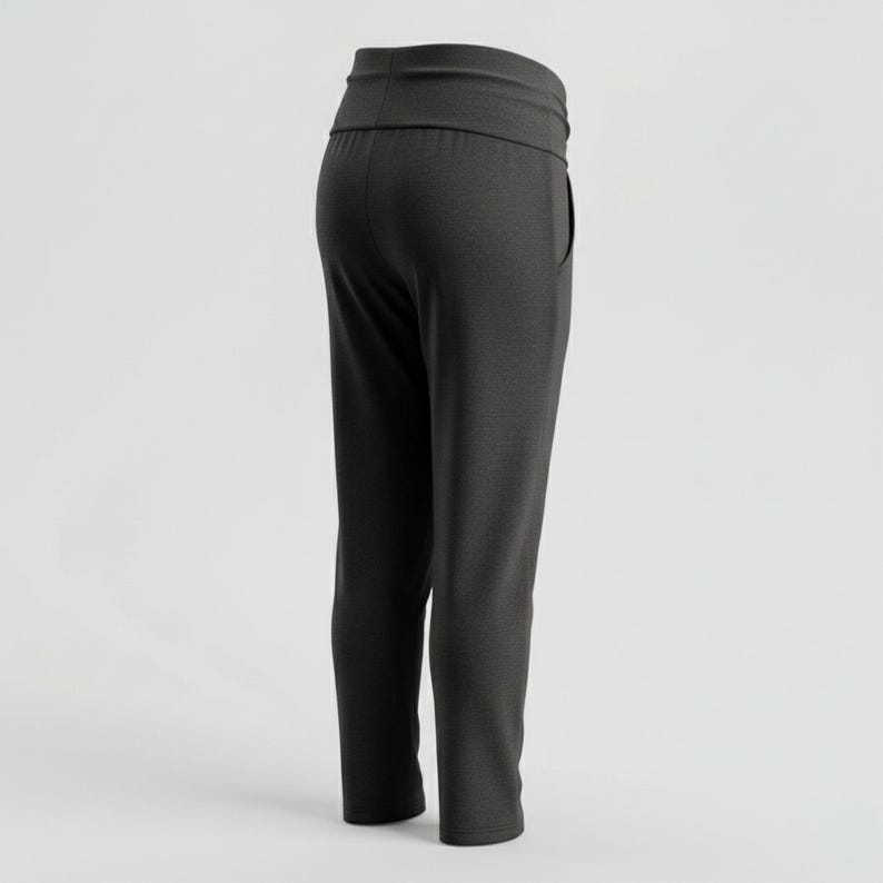 May include: Dark gray athletic pants with a wide waistband and a relaxed fit. The pants have a single pocket on the side and a slightly tapered leg. The fabric appears to be a soft, knit material.