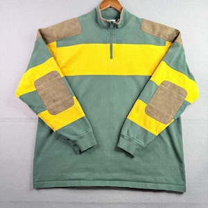 May include: A long-sleeve quarter-zip pullover featuring a color-blocked design in sage green and bright yellow. The garment includes tan suede-like patches on the shoulders and elbows, a high collar with a metal zipper, and ribbed cuffs.