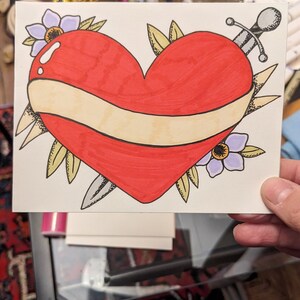 Biglietto d'auguri con cuore e spada