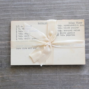 Vintage recipe cards tied with a cream-colored ribbon.