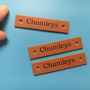 May include: Three brown leather labels with the text "Chumleys" embossed in black.
