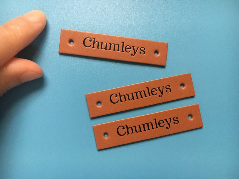 May include: Three brown leather labels with the text "Chumleys" embossed in black.