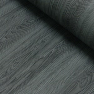 May include: Close-up of a dark grey woodgrain vinyl sheet. The sheet has a realistic woodgrain pattern.