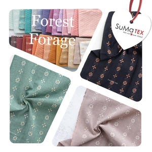 May include: A collection of fabric swatches in various colors including teal, purple, pink, orange, and yellow, featuring a repeating floral pattern. A heart-shaped tag with the text SuMa TEX Mit viel zum Detail is attached by a red ribbon.
