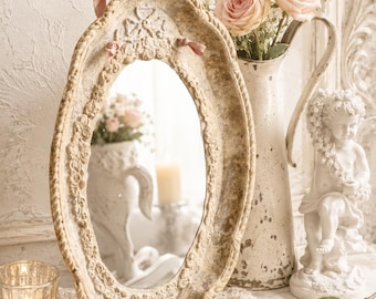 Oval Ochre Metal Wall Mirror with Pink Ribbon and Ornate Clay Border