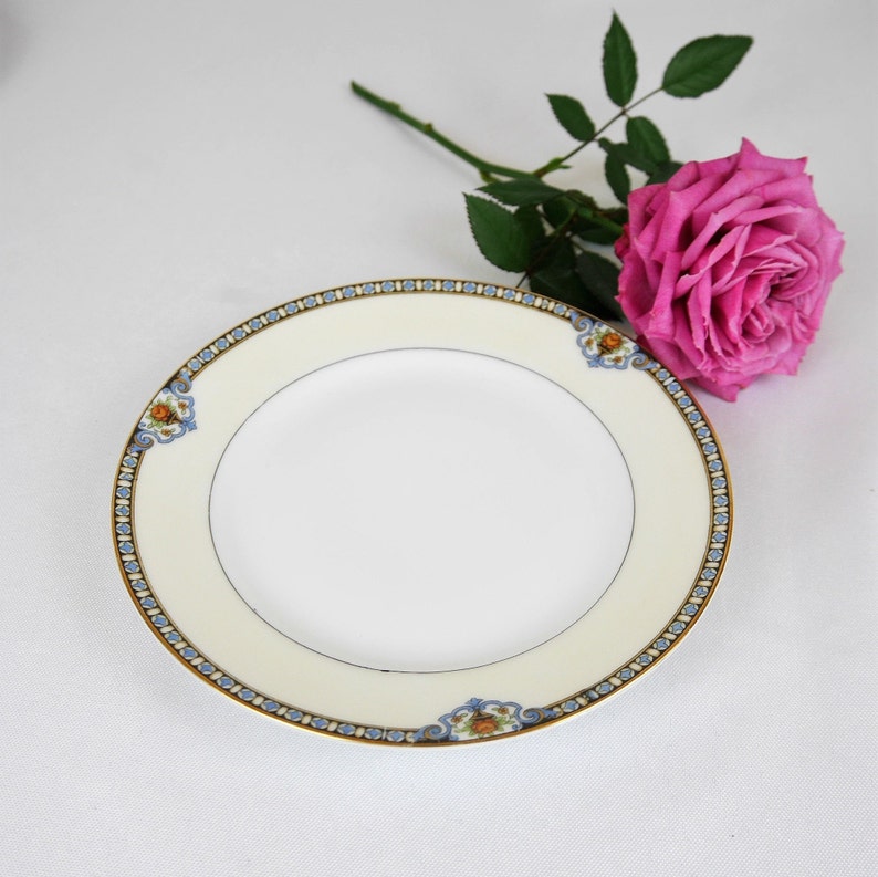 Noritake porcelain bread plates in the original Shirley Art Deco pattern, with old green "M" Morimura stamp. They have a white base with a wide cream border with gilded edges and pretty art deco pattern with roses.