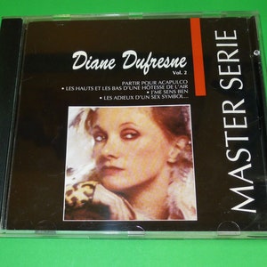 May include: A black CD case with a photo of a woman on the front. The text on the case reads "Diane Dufresne Vol. 2 MASTER SERIE" and "PARTIR POUR ACAPULCO • LES HAUTS ET LES BAS D'UNE HOTESSE DE L'AIR • J'ME SENS BEN • LES ADIEUX D'UN SEX SYMBOL..."