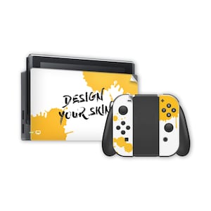 May include: A white and black game console with a yellow and white controller. The console dock has a white background with yellow paint splatters and the text "DESIGN YOUR SKIN". The controller has a matching design.