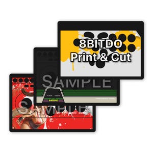 May include: Three rectangular adhesive skins for arcade controllers featuring various graphic designs. The top skin is yellow and white with the text 8BITDO Print & Cut. The middle skin is dark with green accents and the text ASTRO. The bottom skin is red.