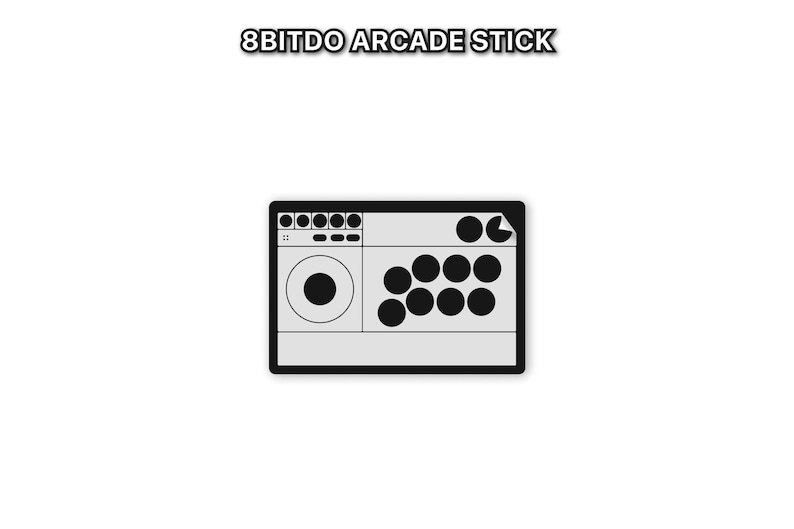 Peut inclure: Un stick d'arcade 8Bitdo gris avec des boutons noirs et un joystick. Le texte "8BITDO ARCADE STICK" est au-dessus du stick d'arcade. Le stick d'arcade a une bordure noire et est sur fond blanc.