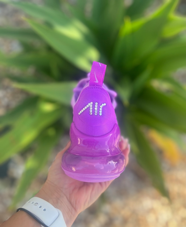 May include: Purple Nike Air Max 270 sneakers with a clear bubble sole and a rhinestone "AIR" logo on the back.