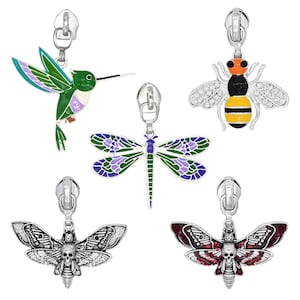 May include: A collection of decorative zipper pulls featuring various insect and animal designs. Includes a hummingbird, dragonfly, bee, and two moth designs. The pulls are silver-toned metal with enamel details in various colors.