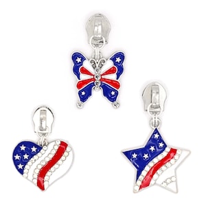 May include: Three patriotic zipper pulls in the shape of a butterfly, heart, and star. The butterfly has blue wings with white stars and red and white stripes. The heart and star have a similar design, with red and white stripes and blue fields with white stars. All have silver-tone zipper pulls.