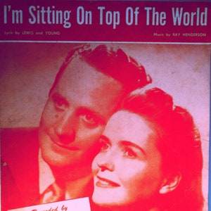May include: A vintage sheet music cover featuring a black and white photo of a couple. The title of the song is "I'm Sitting On Top Of The World". The song is recorded by Les Paul and Mary Ford on Capitol Record #2400. The music is by Ray Henderson and the lyrics are by Lewis and Young. The sheet music is published by Leo Feist Inc. in New York.