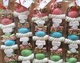 May include: Sweet marshmallow skewers with colourful sprinkles and candies, wrapped in cellophane. Each skewer has a tag that says "Thank you for coming to my party! Love Georgia xx."