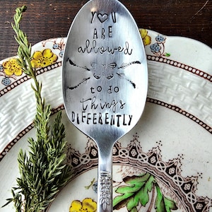 May include: A silver spoon with the words "You are allowed to do things differently" engraved on it. A butterfly is also engraved on the spoon.
