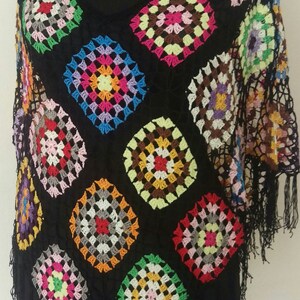 May include: A black crochet top with colourful granny squares and fringe trim.