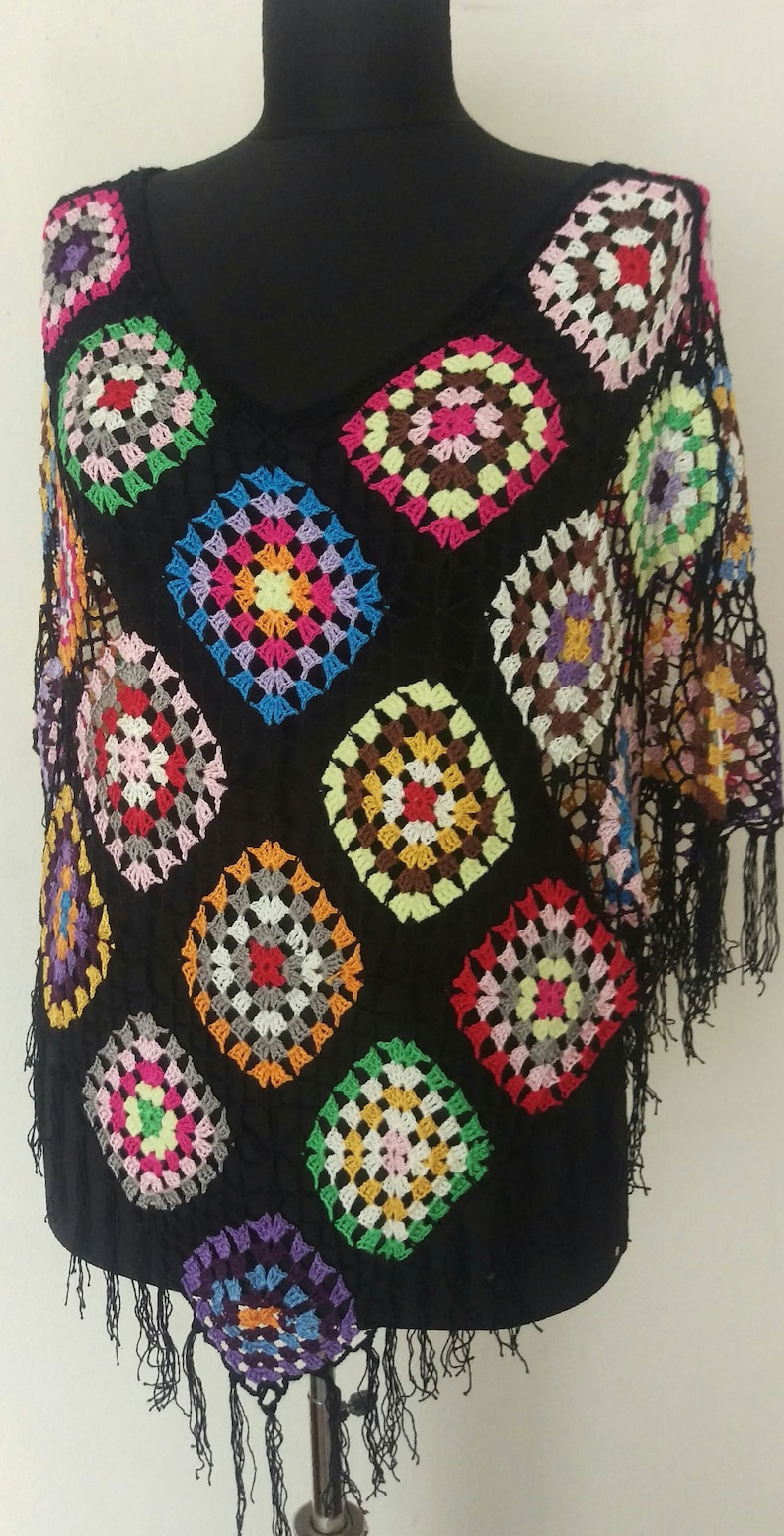 May include: A black crochet top with colourful granny squares and fringe trim.
