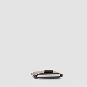 Slim-profile dark brown leather card holder, perfect for organizing credit cards in style
