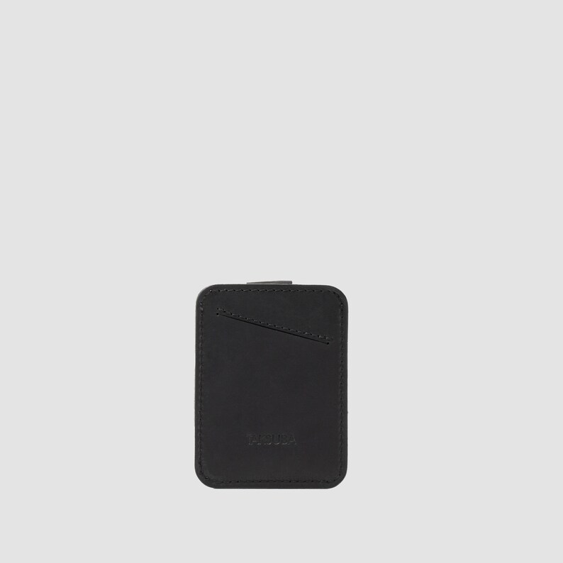 "Sleek black leather card holder with easy-pull tab, stores up to 8 cards in a compact design
